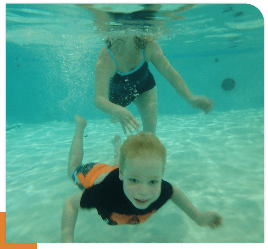 Child Learning to Swim Underwater